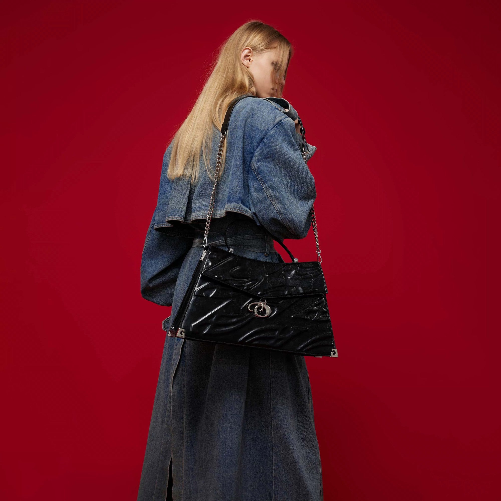 Model wearing the 3D relief tote bag in a street setting