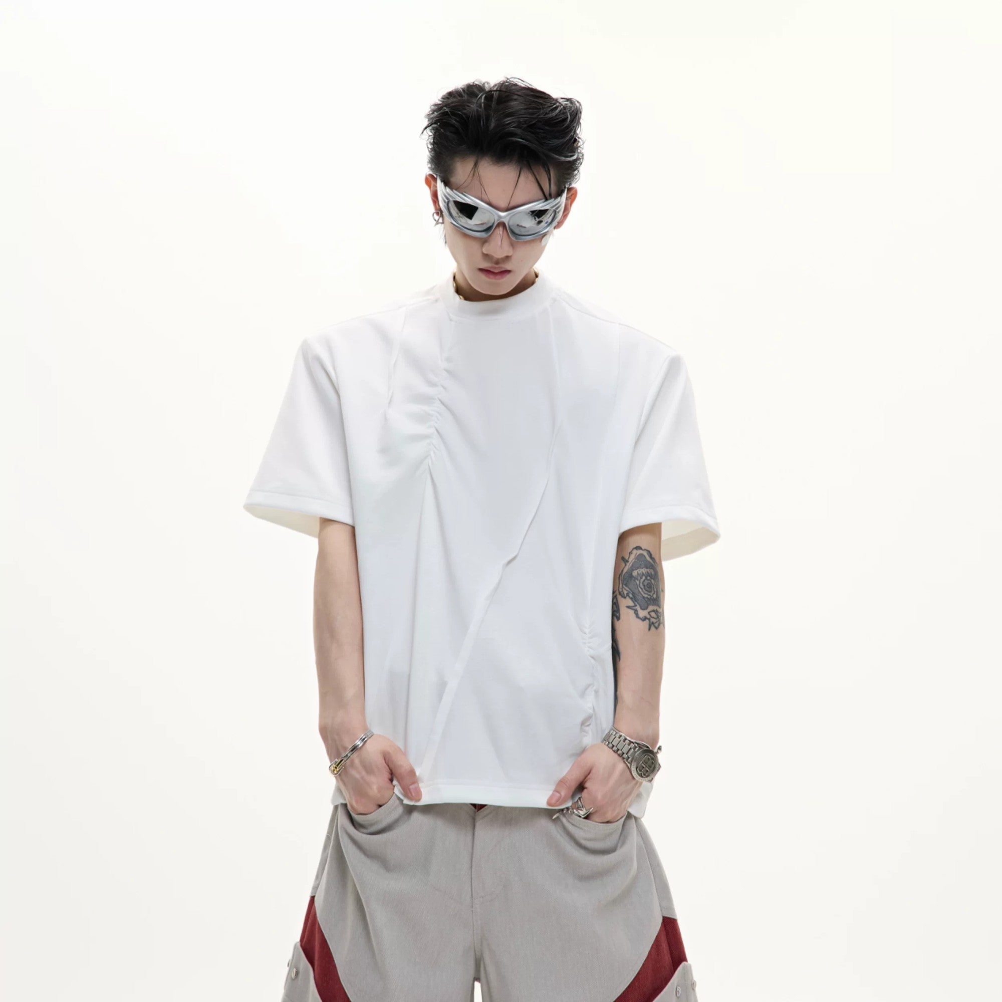 Male Model Wearing Baggy Deconstructed Pleated Tee in Urban Setting