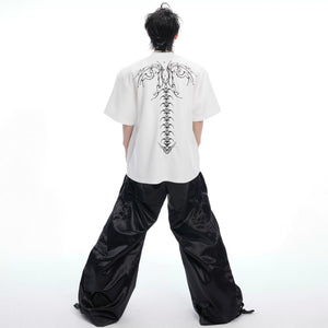 Model wearing the oversized spine embroidery tee in a street setting