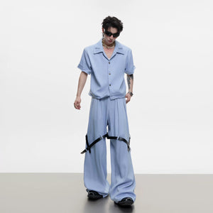 Model wearing blue avant-garde deconstructed short sleeve jacket and pants set