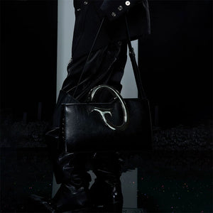 Model wearing the avant-garde crossbody bag in a street setting