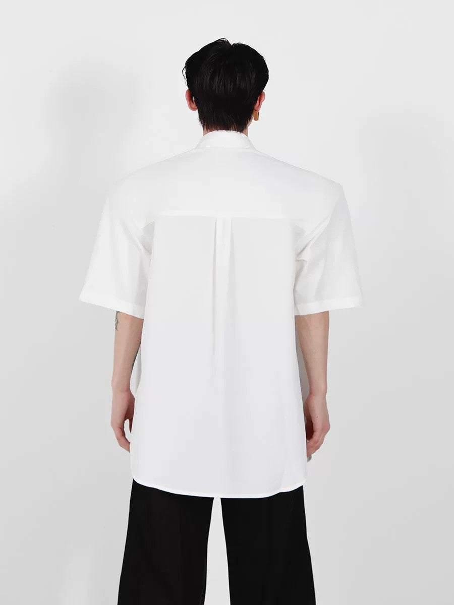 Back view of loose fit minimalist white shirt for summer