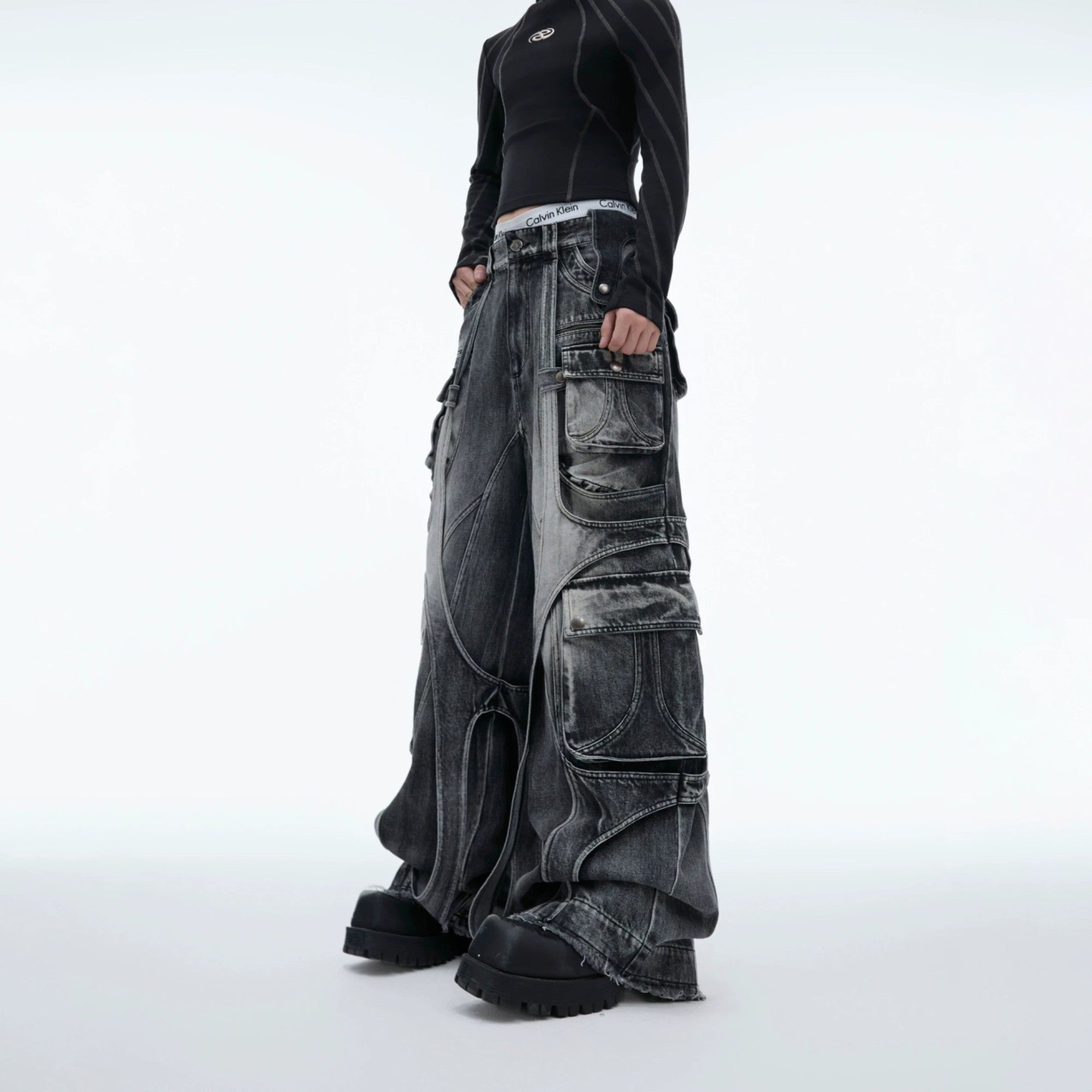 Side profile of black deconstructed cargo pants showing pocket details