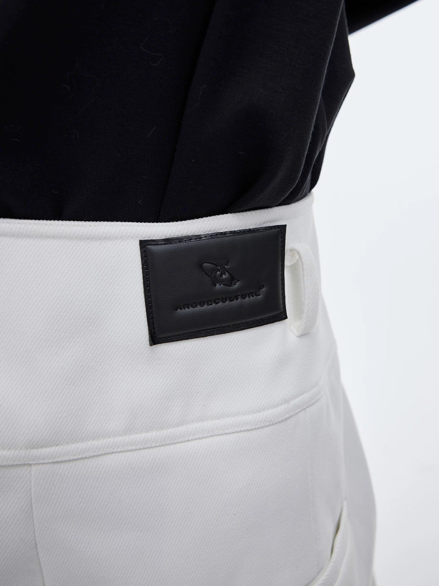 Side view of white high-waisted wide leg trousers with ribbon details