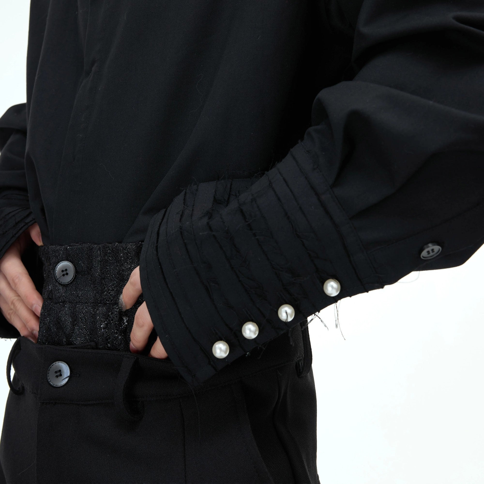 Black oversized shirt featuring unique fringe tassel details on sleeves