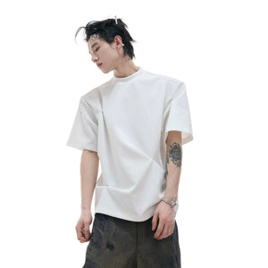 Close-up of the deconstructed pleated texture on a boxy streetwear tee