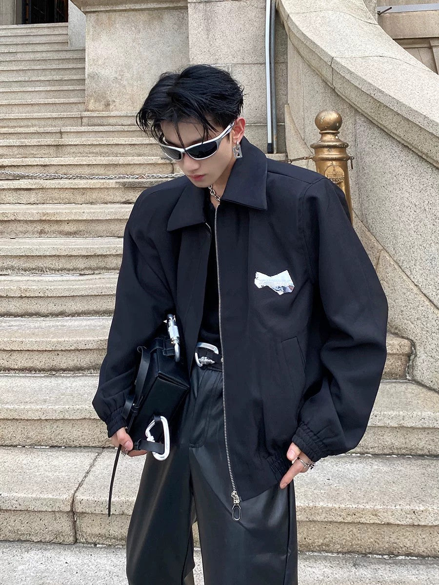 Black minimalist padded shoulder jacket in a boxy cropped fit front view