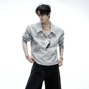 Model wearing gray boxy polo sweatshirt in street setting