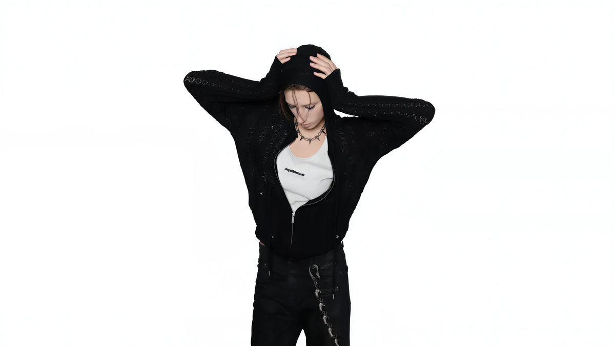 Model wearing a black hooded outfit
