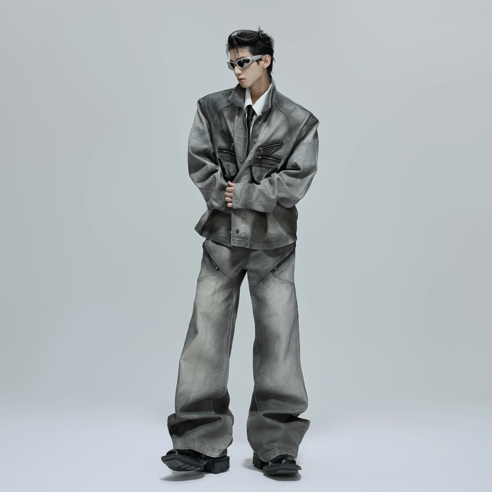 Close up of the boxy shoulder pads and zipper detail on denim jacket.