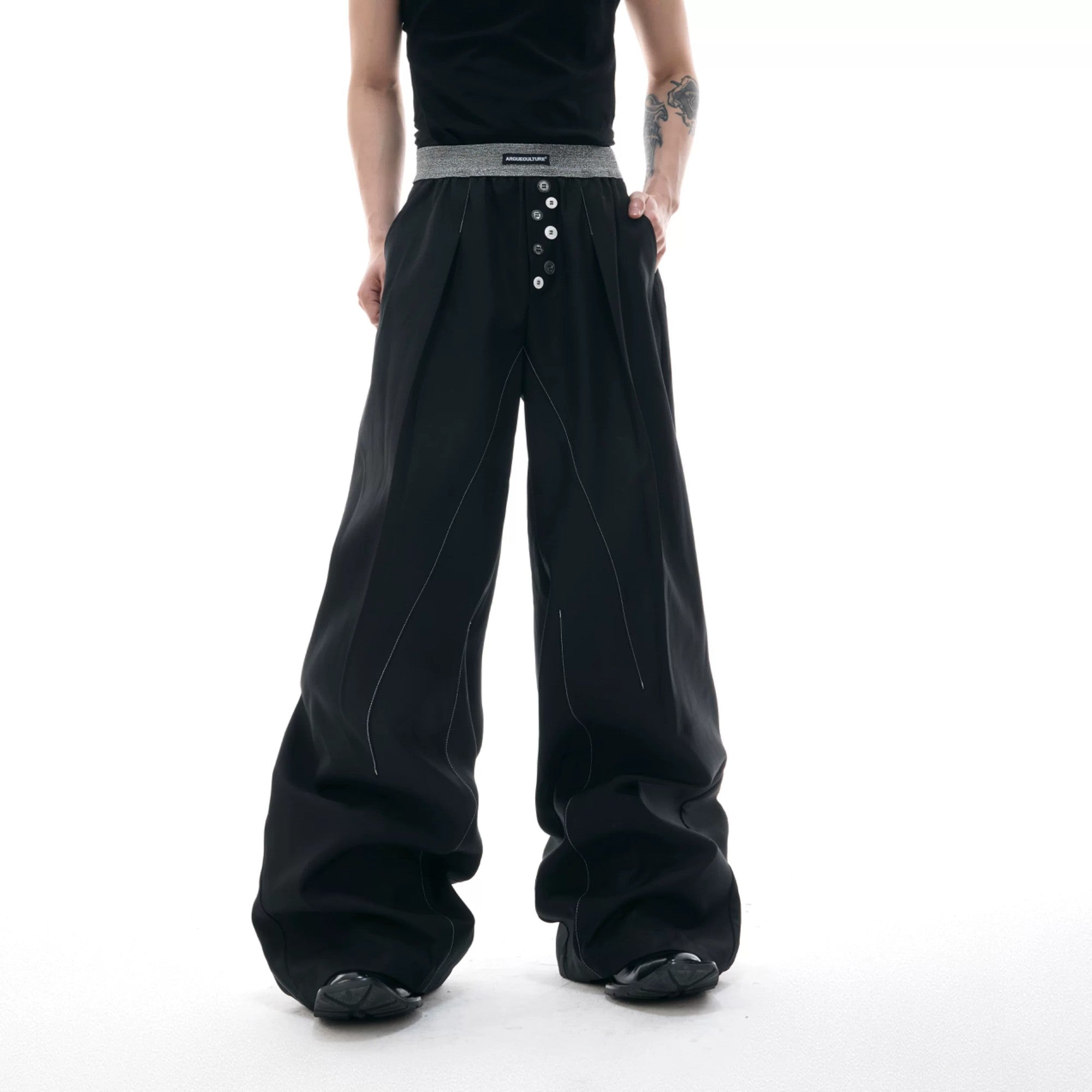 Unisex black straight leg trousers with white contrast stitching details