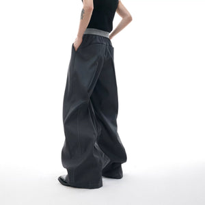 Model wearing black wide leg pants with a minimalist street style outfit