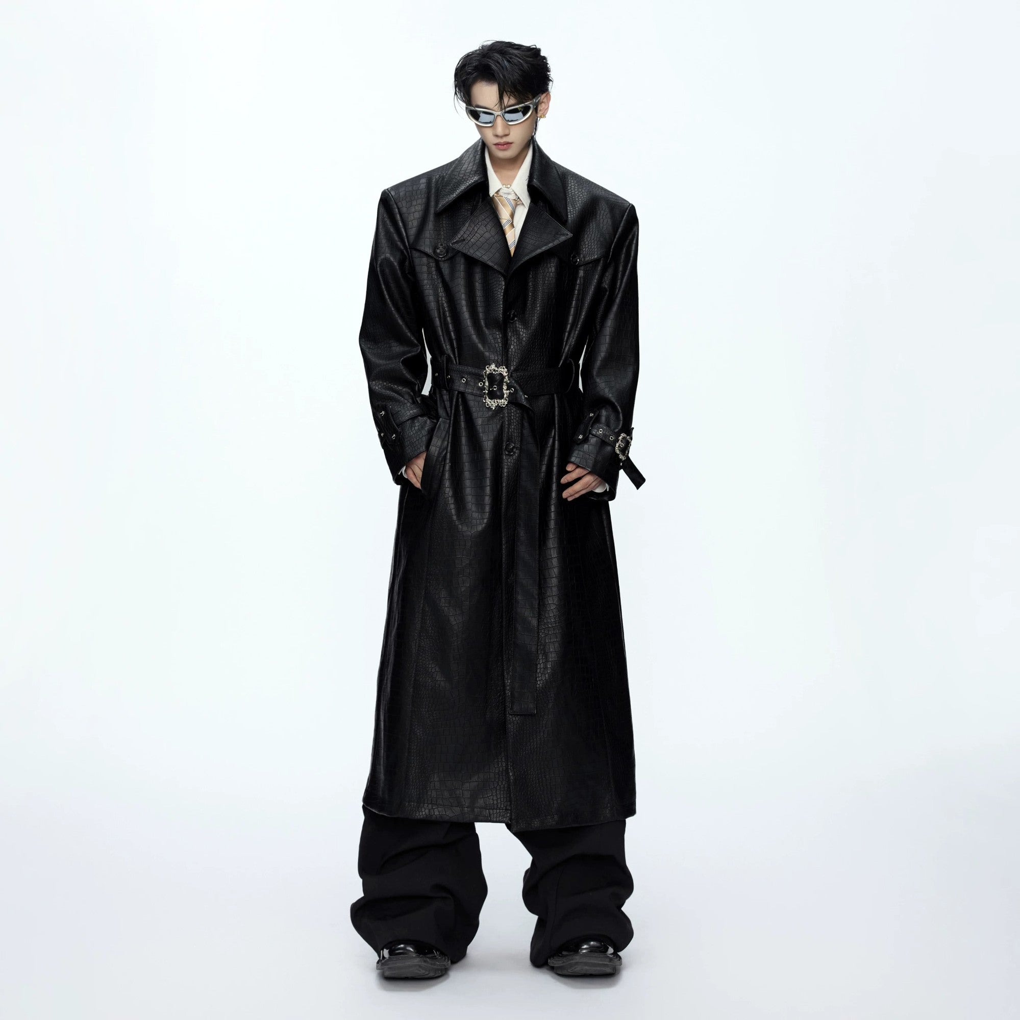 Front view of black croc-embossed wide-shoulder leather trench coat