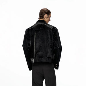 Back view of black faux leather jacket showing panelled hem design