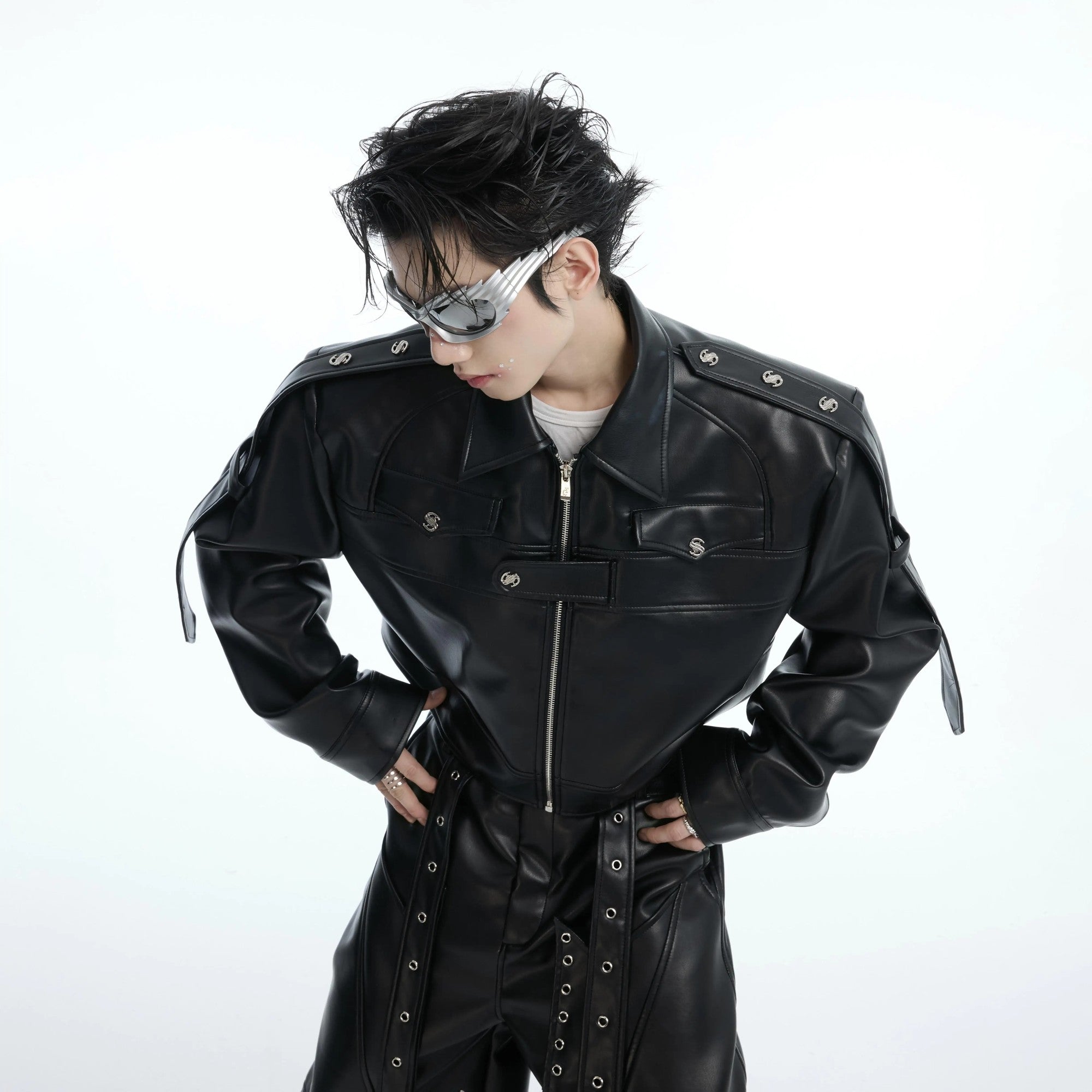 Close up of metal hardware and deconstructed stitching on a black biker jacket