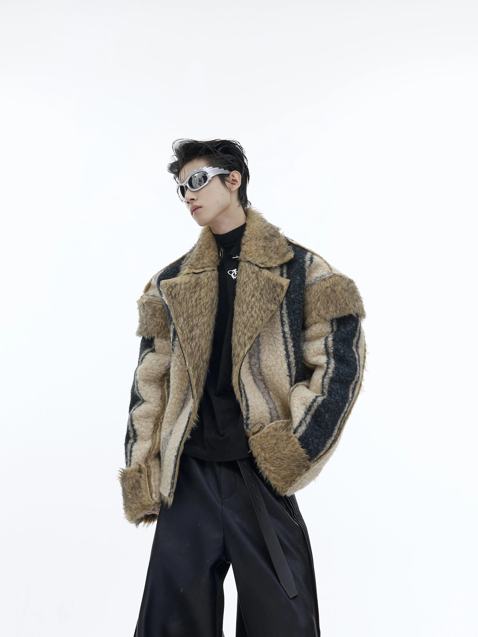 Close up of the deconstructed patchwork stitching on the faux fur jacket