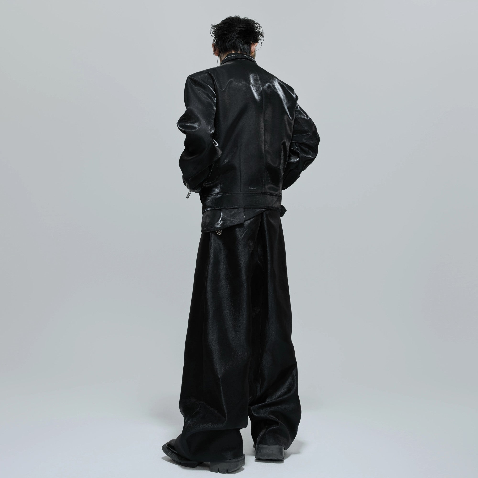 Model wearing black metallic cropped jacket with baggy jeans