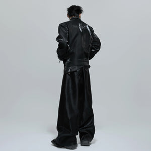 Model wearing black metallic cropped jacket with baggy jeans