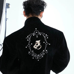 Close up of metallic snake emblem and pearl details on back of jacket