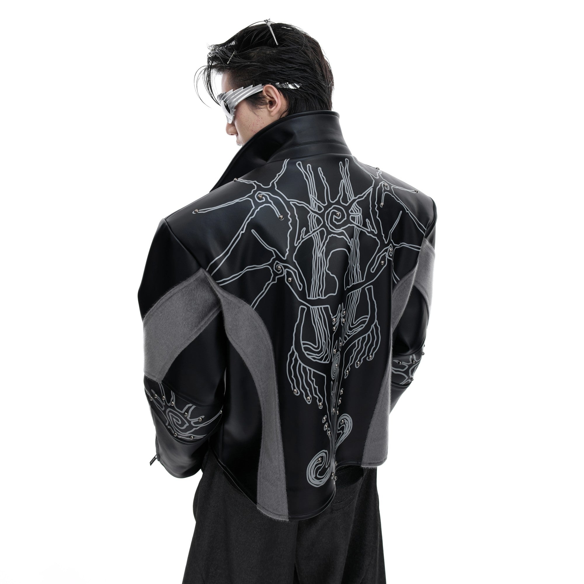 Front view of black deconstructed leather jacket with rivets
