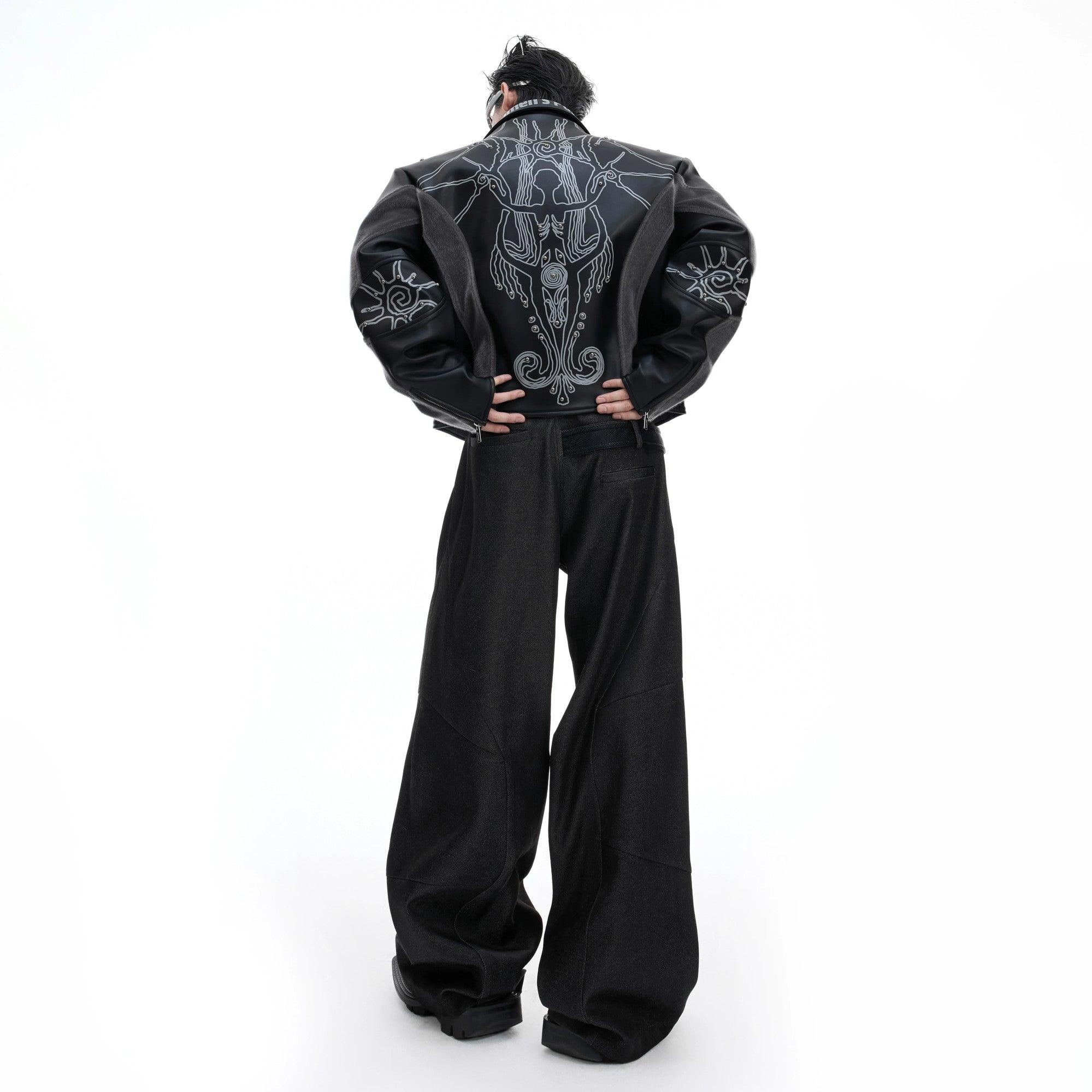 Model wearing cropped gothic leather jacket in urban setting