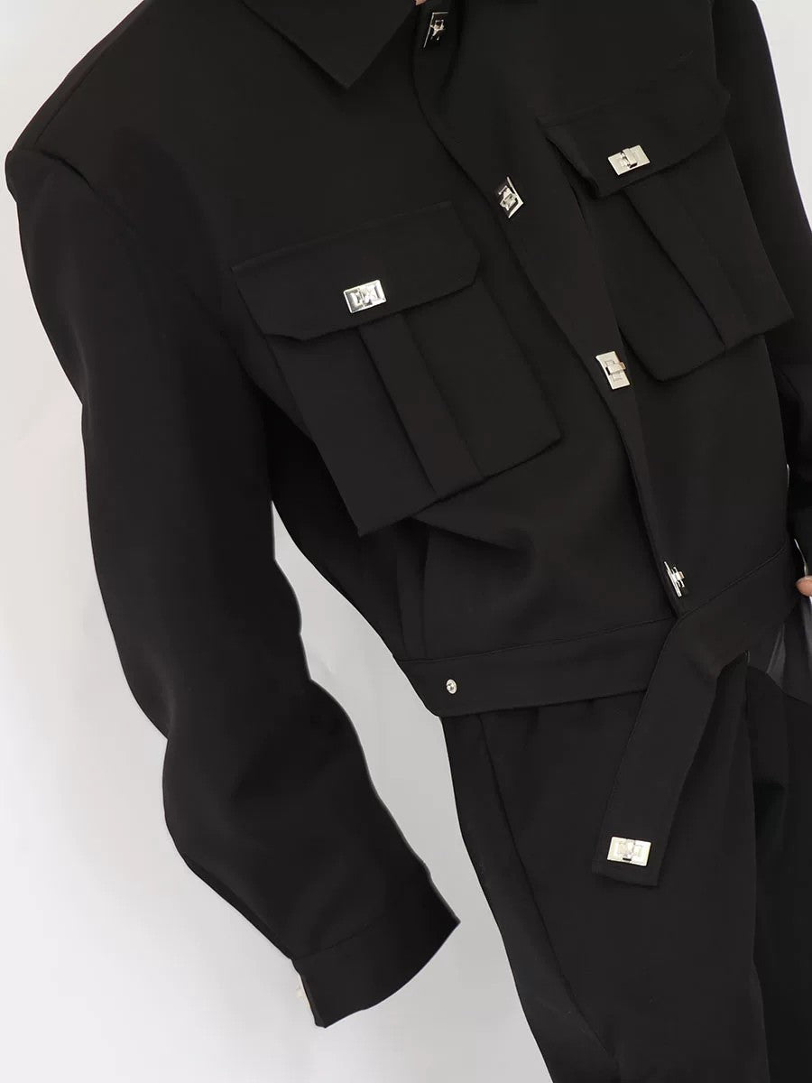 Close up of structured shoulder padding and metal button hardware on jacket