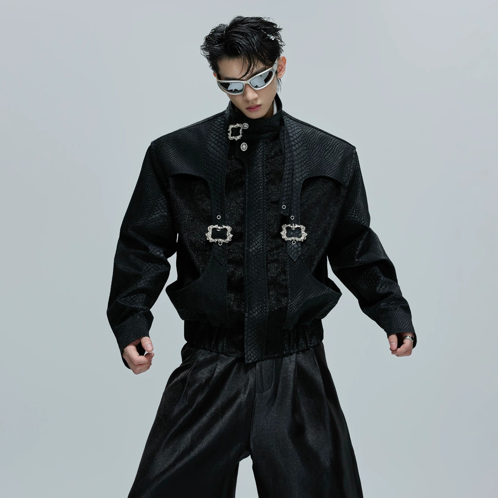 Front view of a cropped snake skin moto jacket with metal buckle details