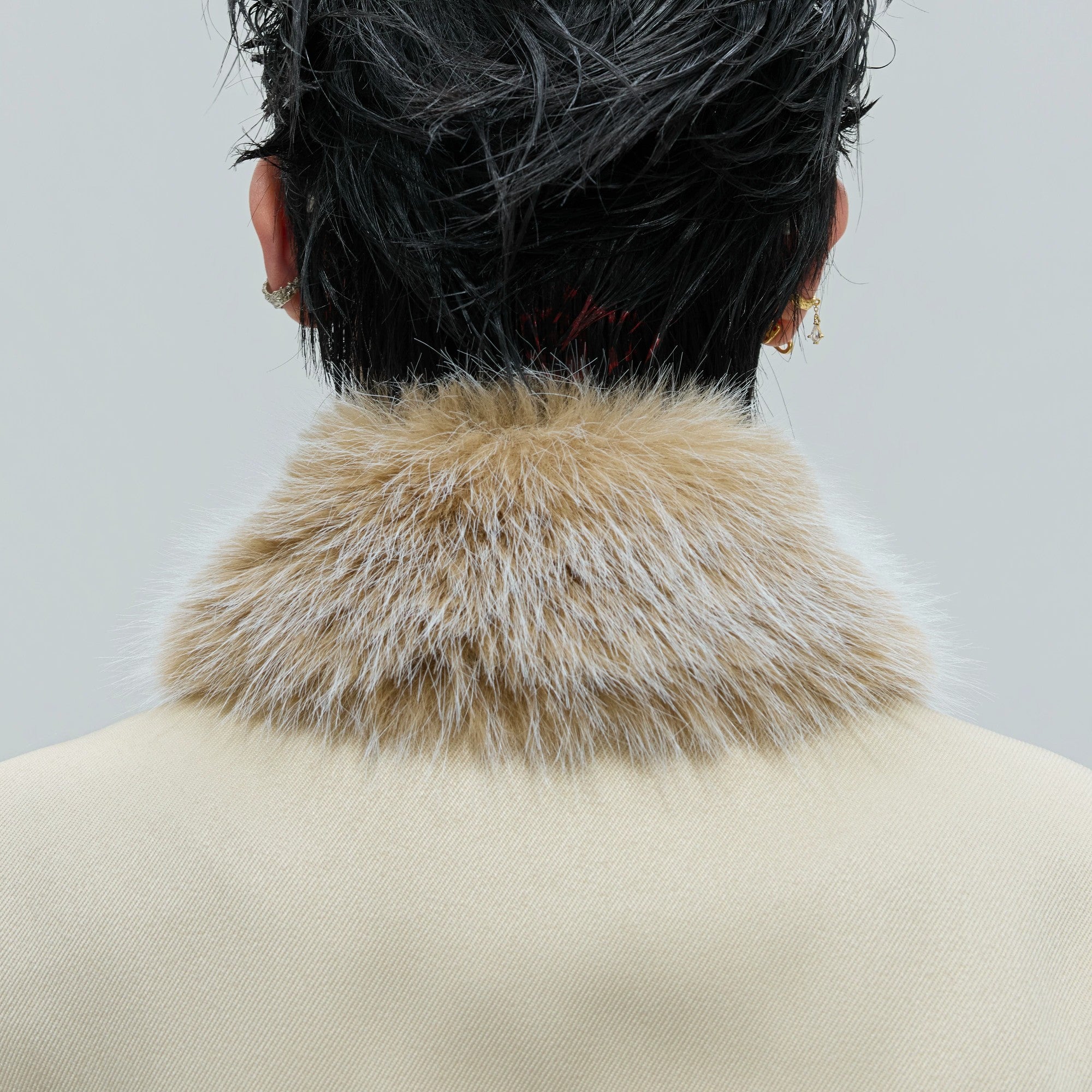 Model wearing dark red cropped jacket set with pleated details