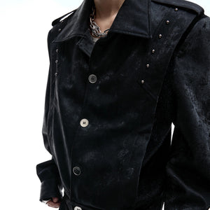 Close-up of nickel-plated studs and snakeskin leather texture