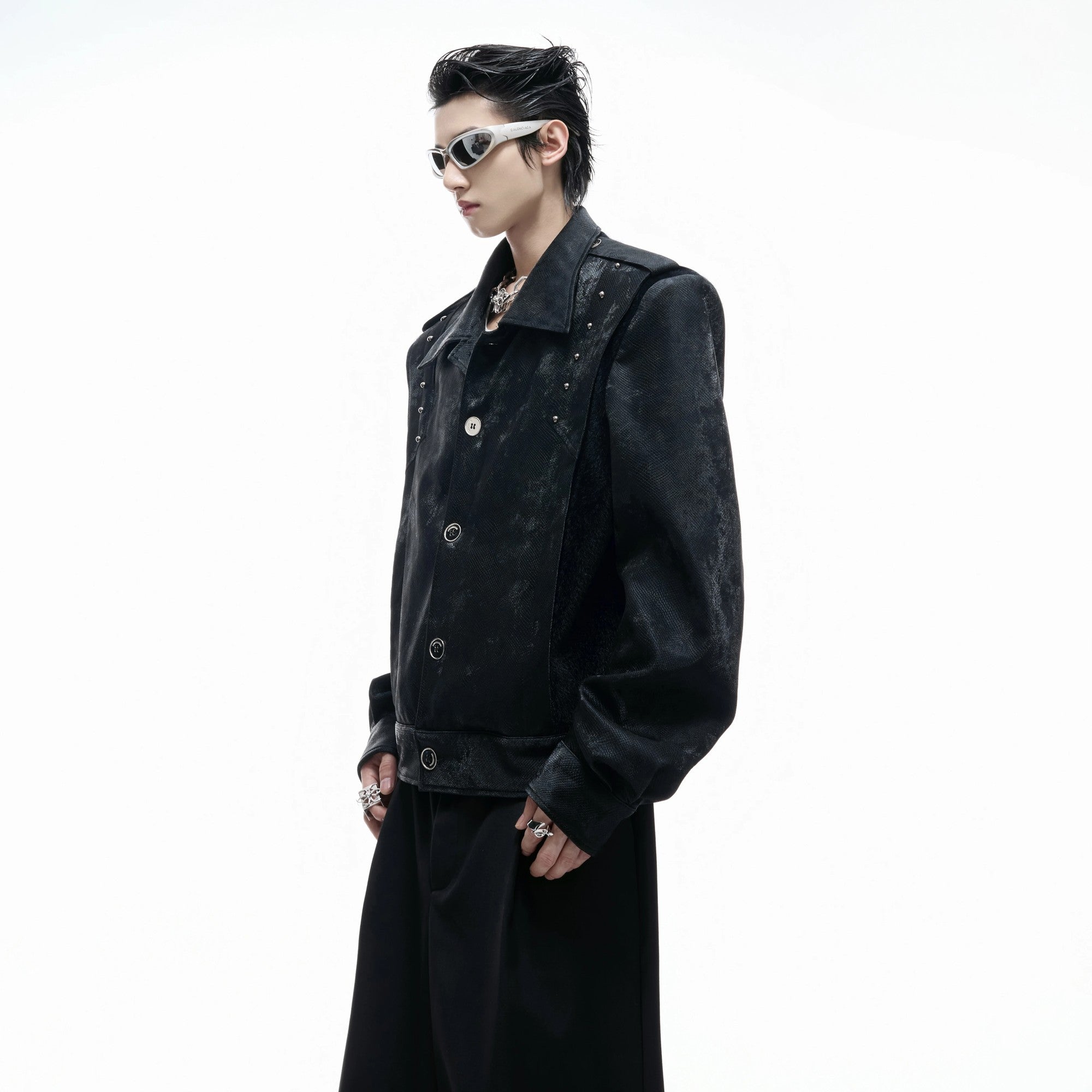 Side profile of the loose fit cropped leather jacket with metal buttons