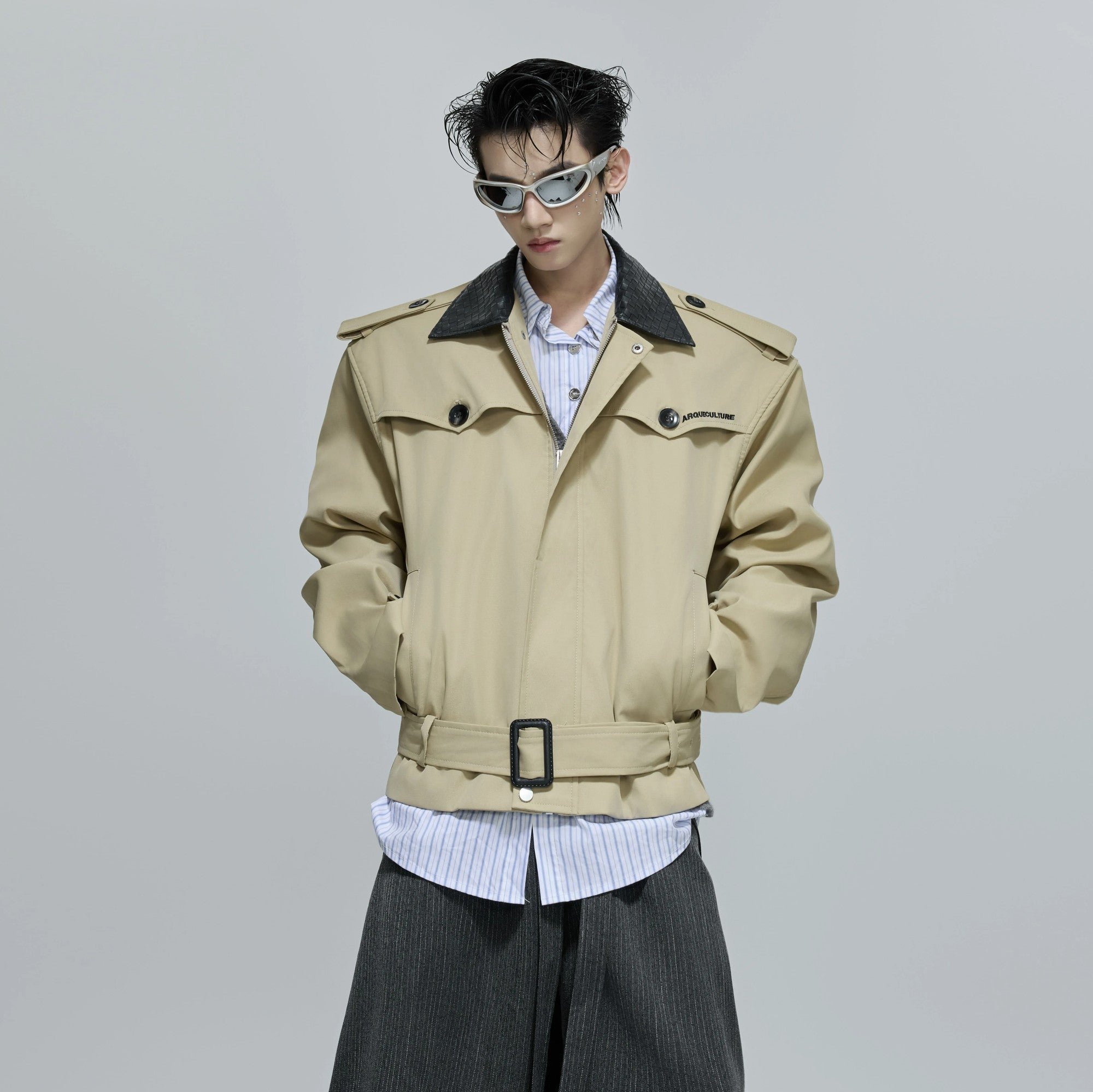 Front view of a cropped woven leather patchwork jacket in red and black.