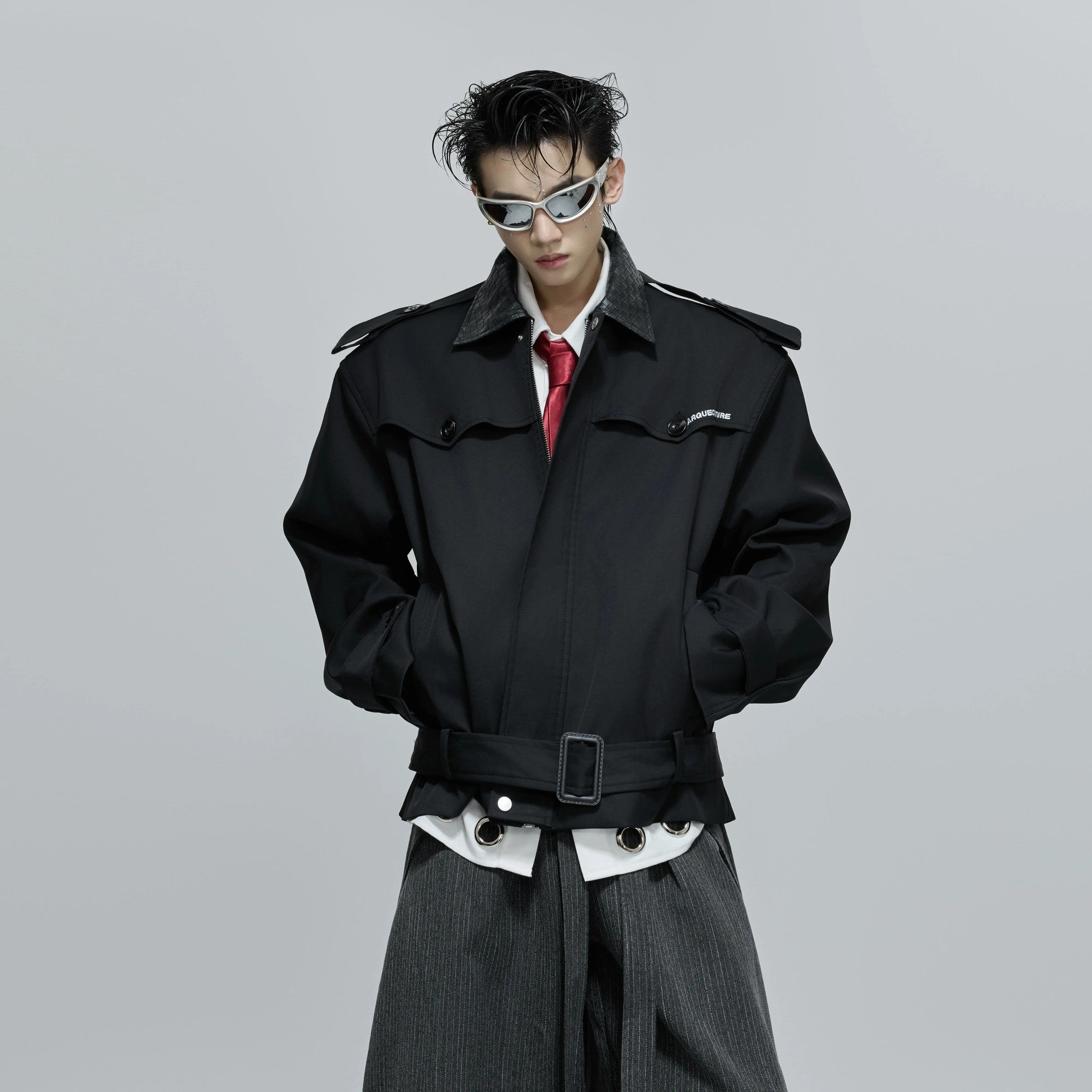 Close-up of the woven leather texture and embroidery on the sleeve.