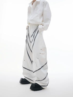 Black deconstructed trousers with 3D cut and metal rivet details front view