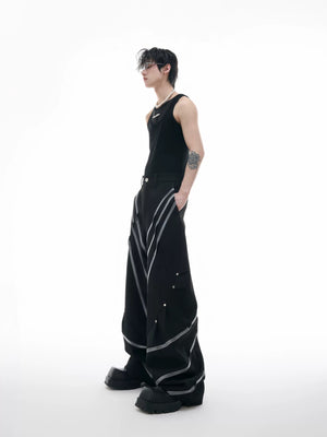 Model wearing black 3D cut trousers in an urban street setting