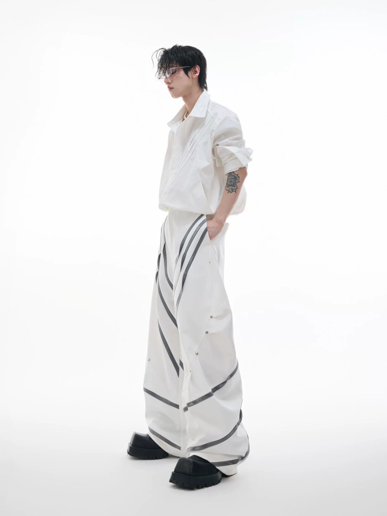 Back view of high-waist deconstructed trousers showing pocket detail