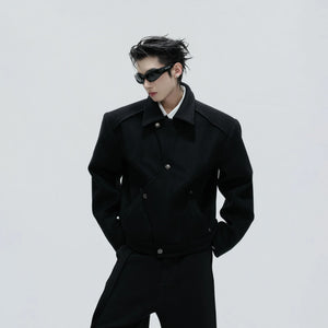 Side view of black deconstructed wool jacket showing asymmetric tailoring