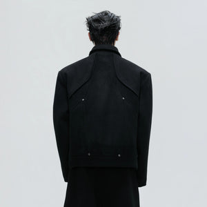Back view of the deconstructed wool coat showing unique paneling lines