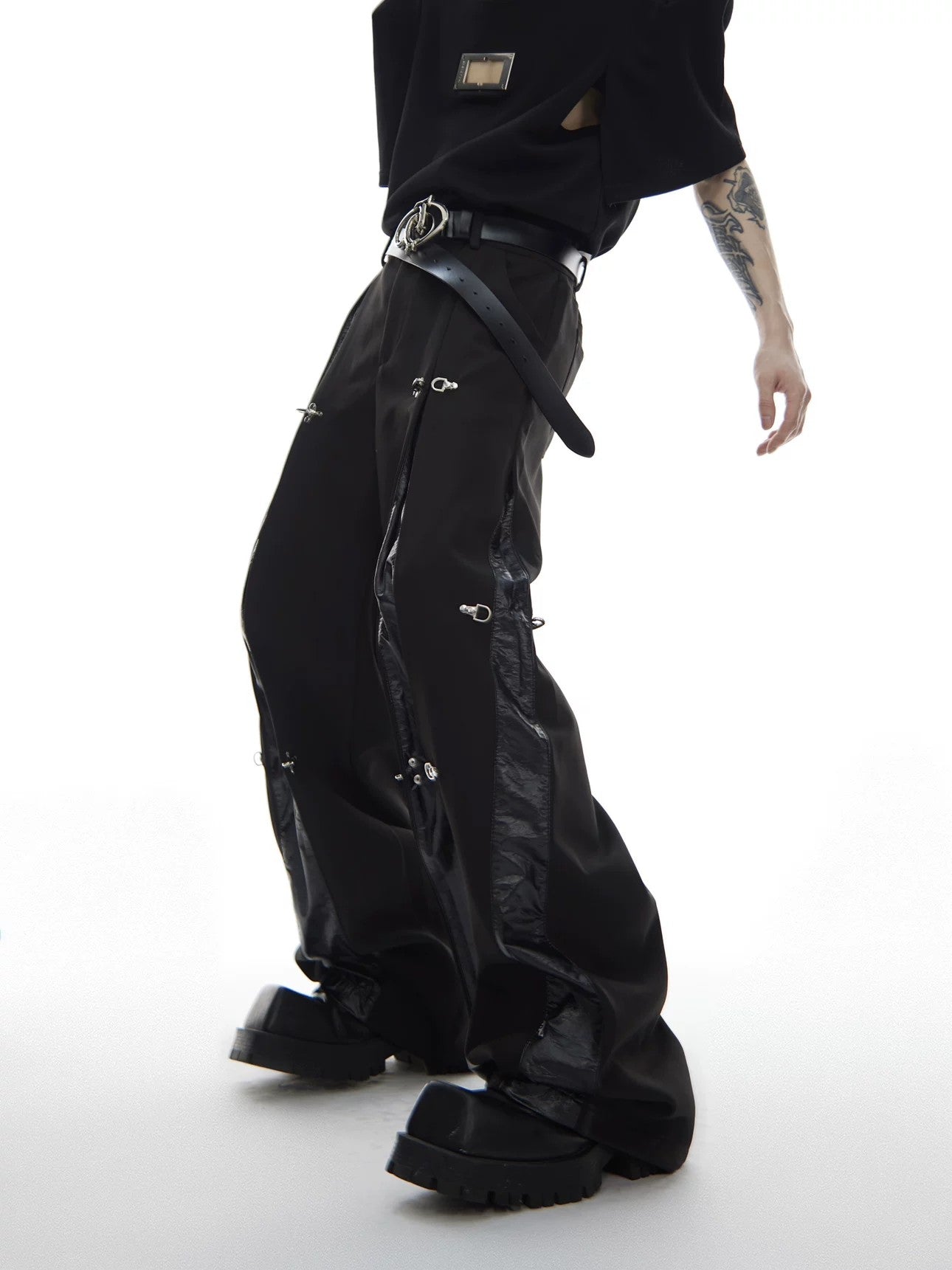 Side profile of straight leg pants showing leather design details