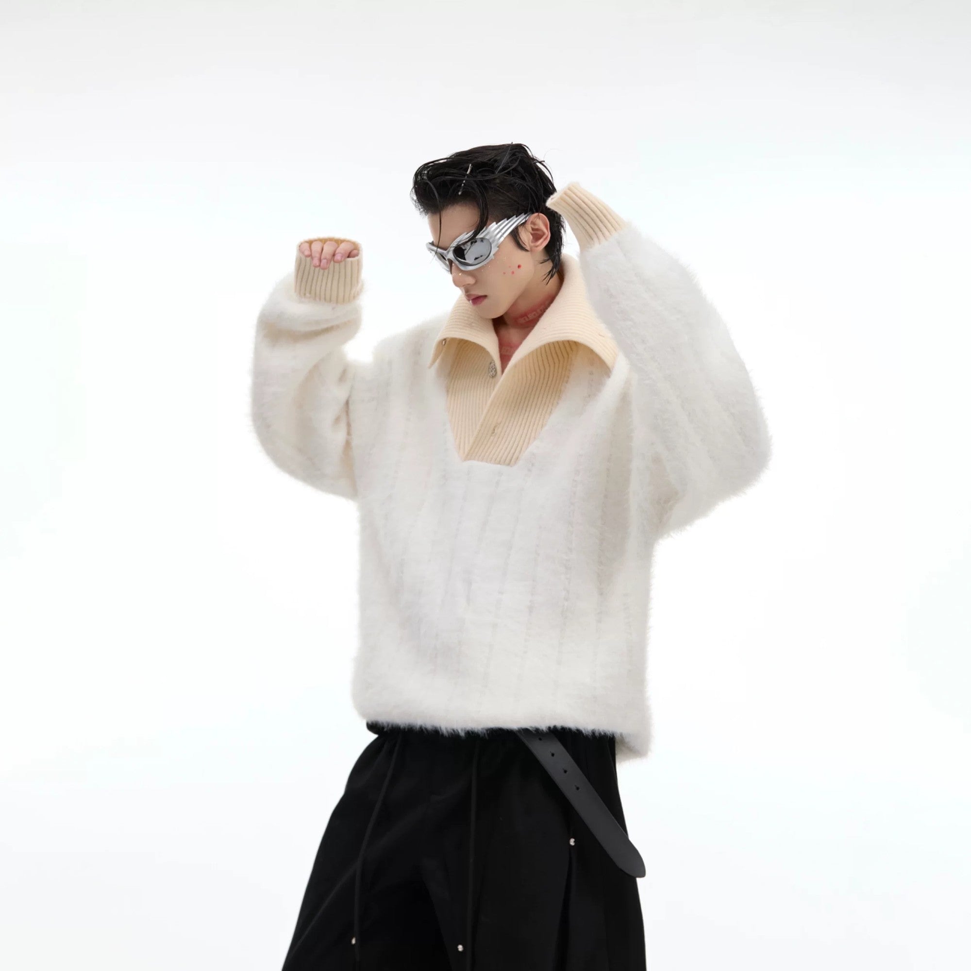 Close up detail of the white buttoned turtleneck and knit texture