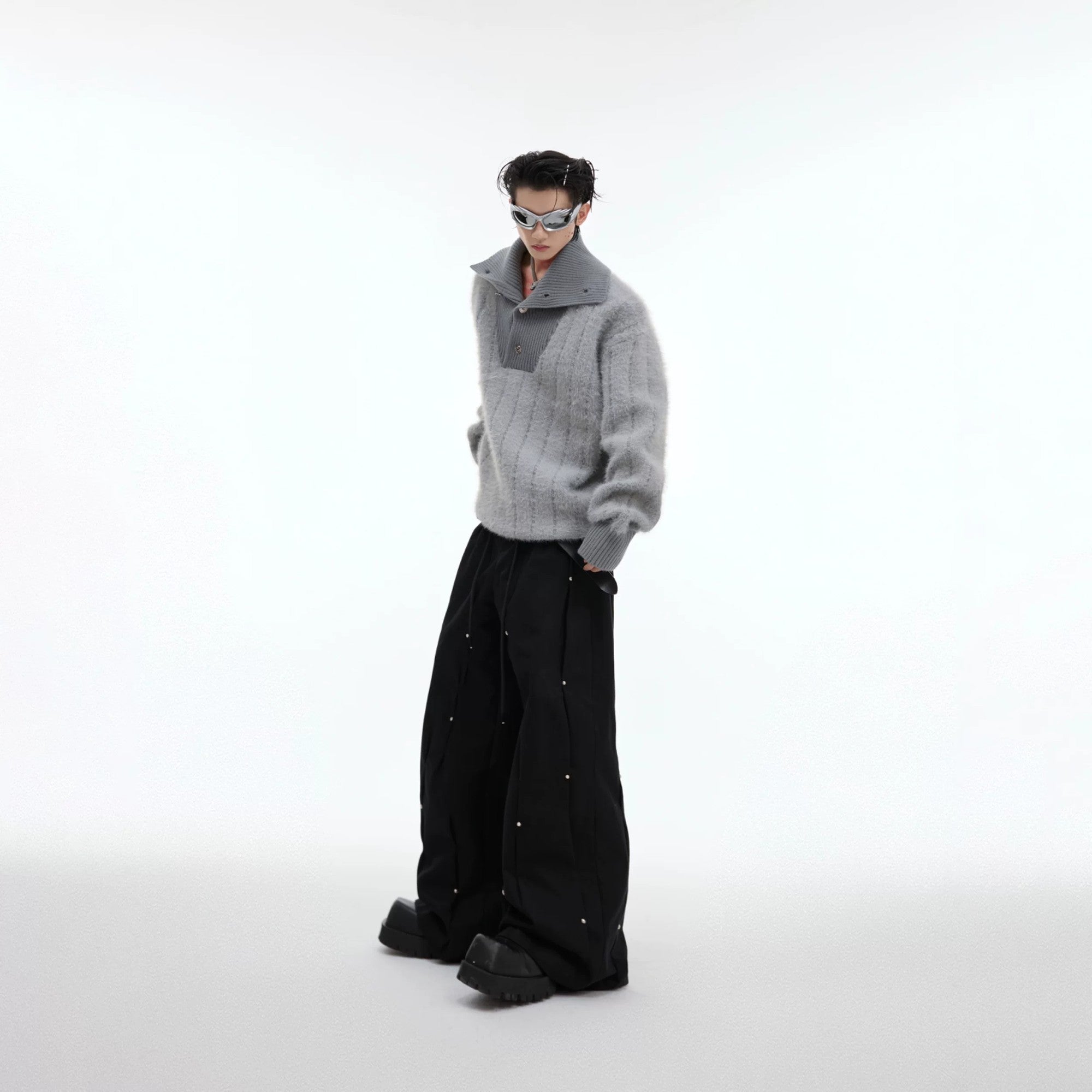 Stylized lifestyle shot of the deconstructed knit sweater at a party