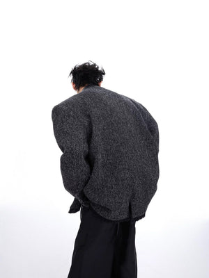 Close-up of the 3D split tailoring and spliced fabric details on a gray jacket.
