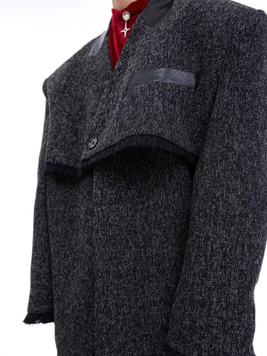 Lifestyle shot of the gray deconstructed blazer paired with streetwear accessories.