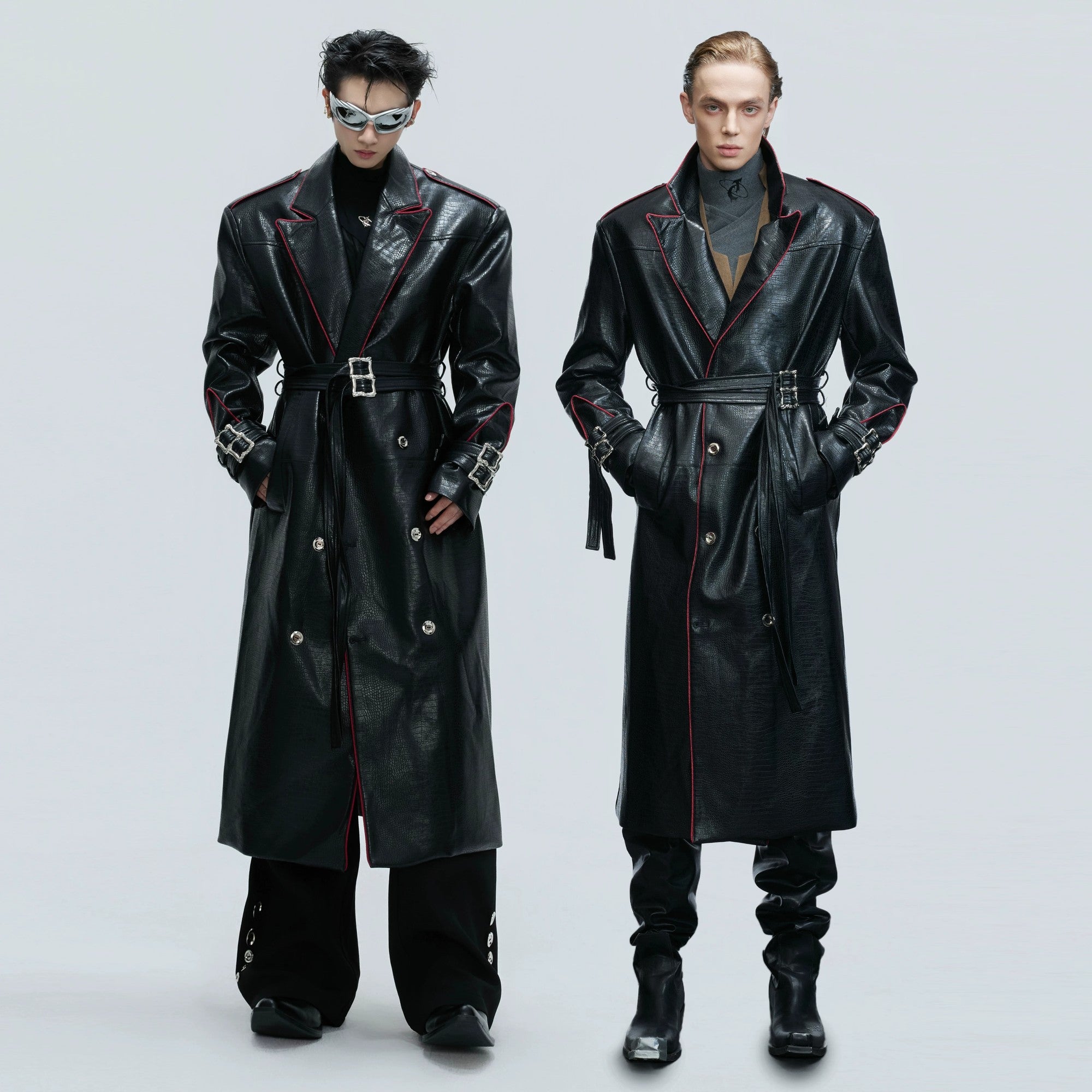 Front view of a deconstructed black croc-effect leather long coat with wide shoulders