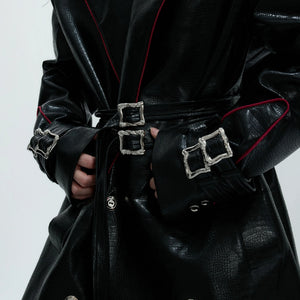 Detailed shot of the zipper cuff design on a deconstructed leather coat