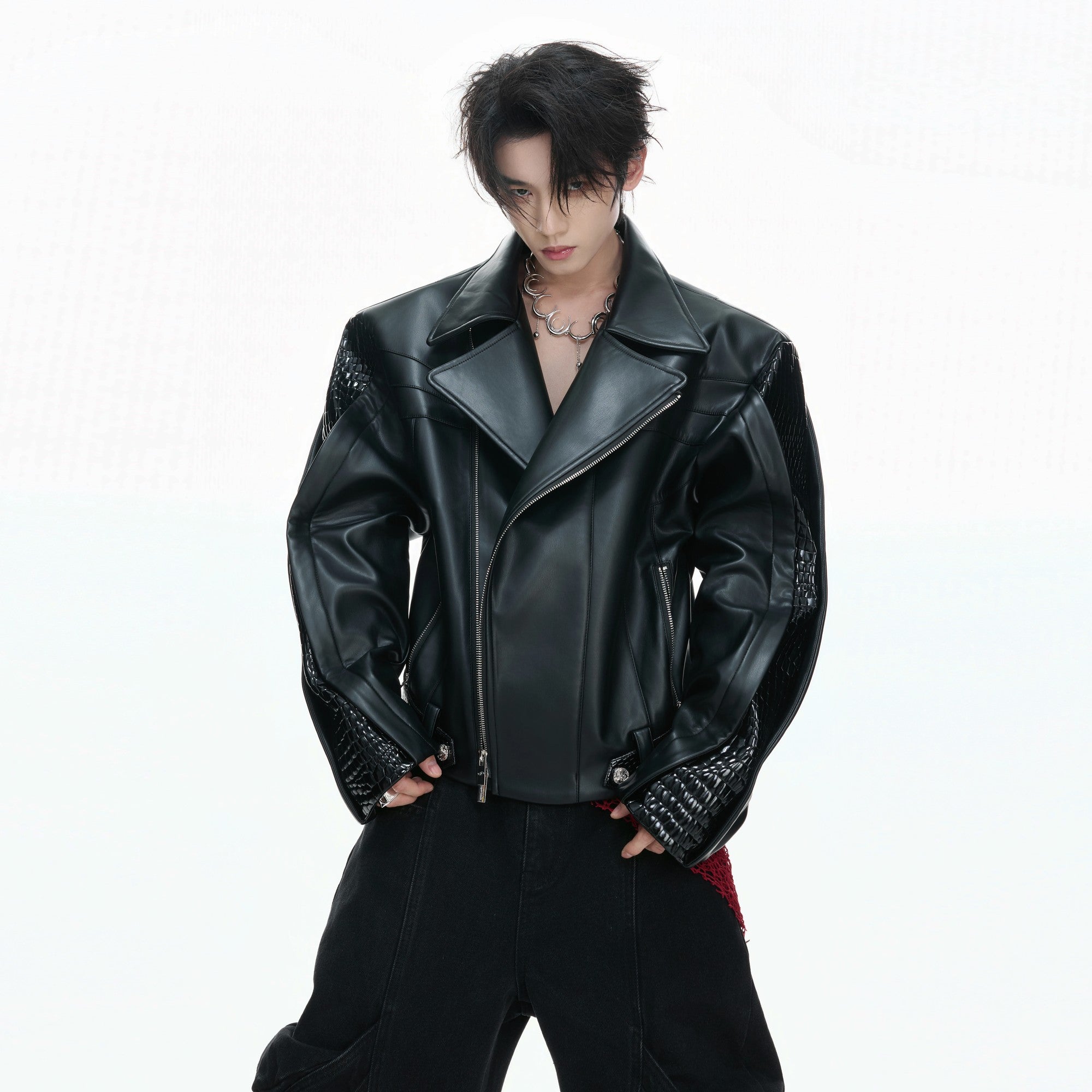 Back view of the short cropped deconstructed leather jacket with patchwork