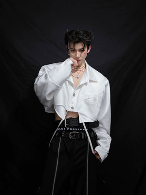 Model wearing a white deconstructed cropped shirt in a street setting