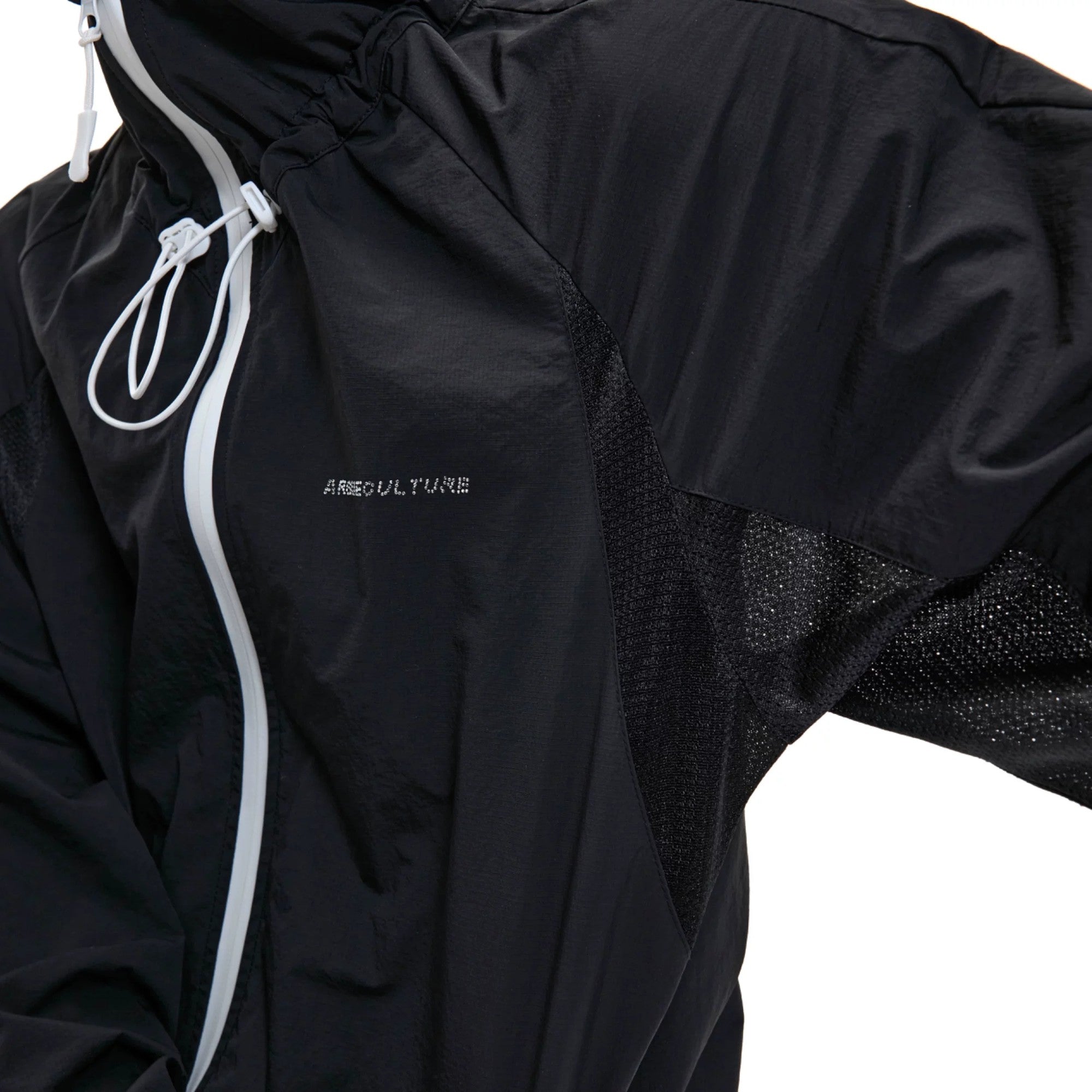 Flatlay of the black waterproof cropped sun jacket