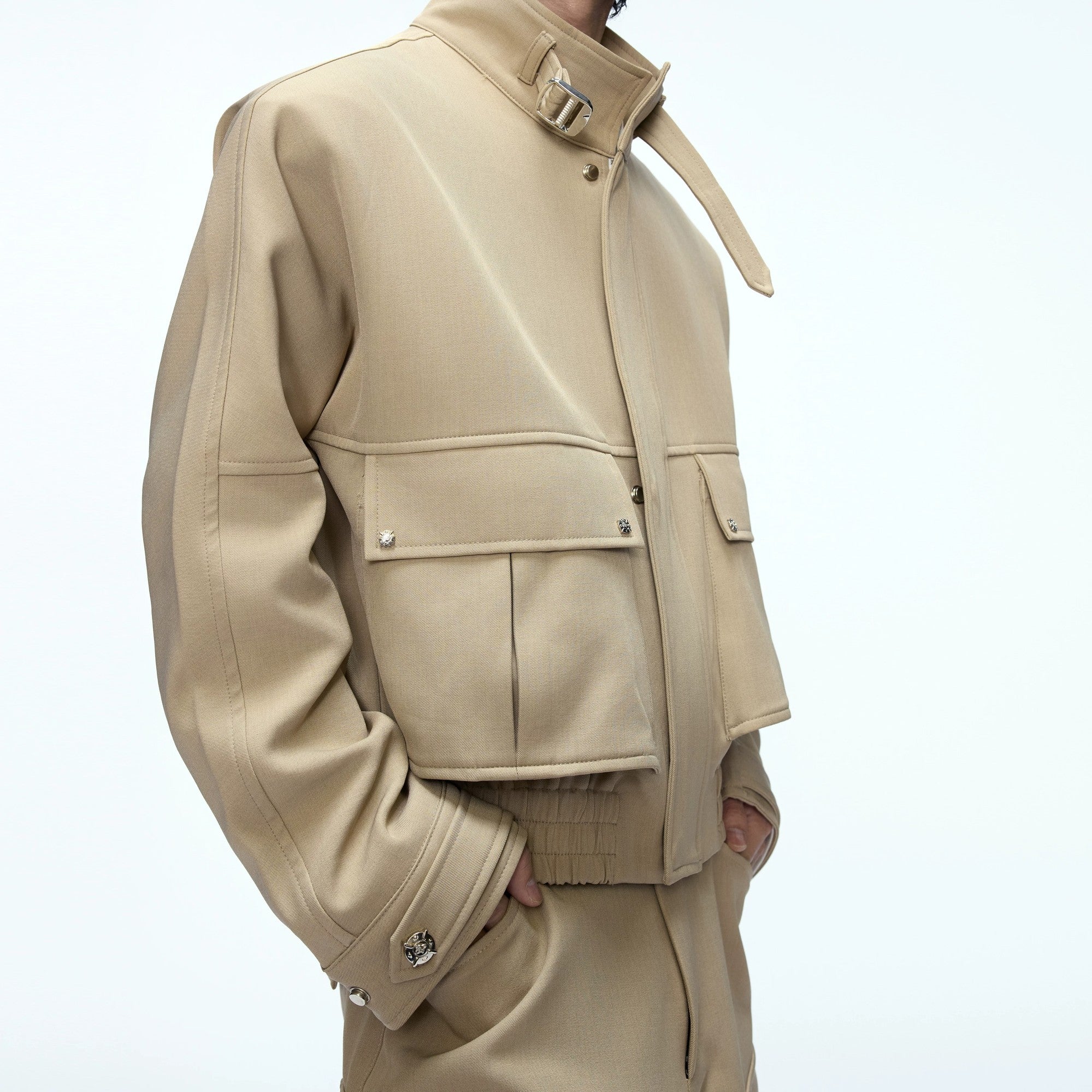 Model wearing a deconstructed workwear suit in a street setting