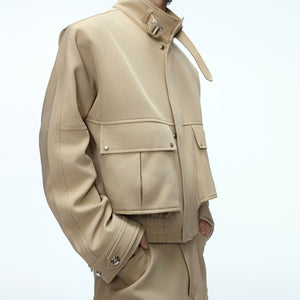 Model wearing a deconstructed workwear suit in a street setting