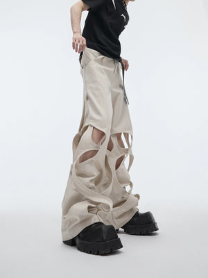 Side view of white baggy cargo pants with unique cut-out details